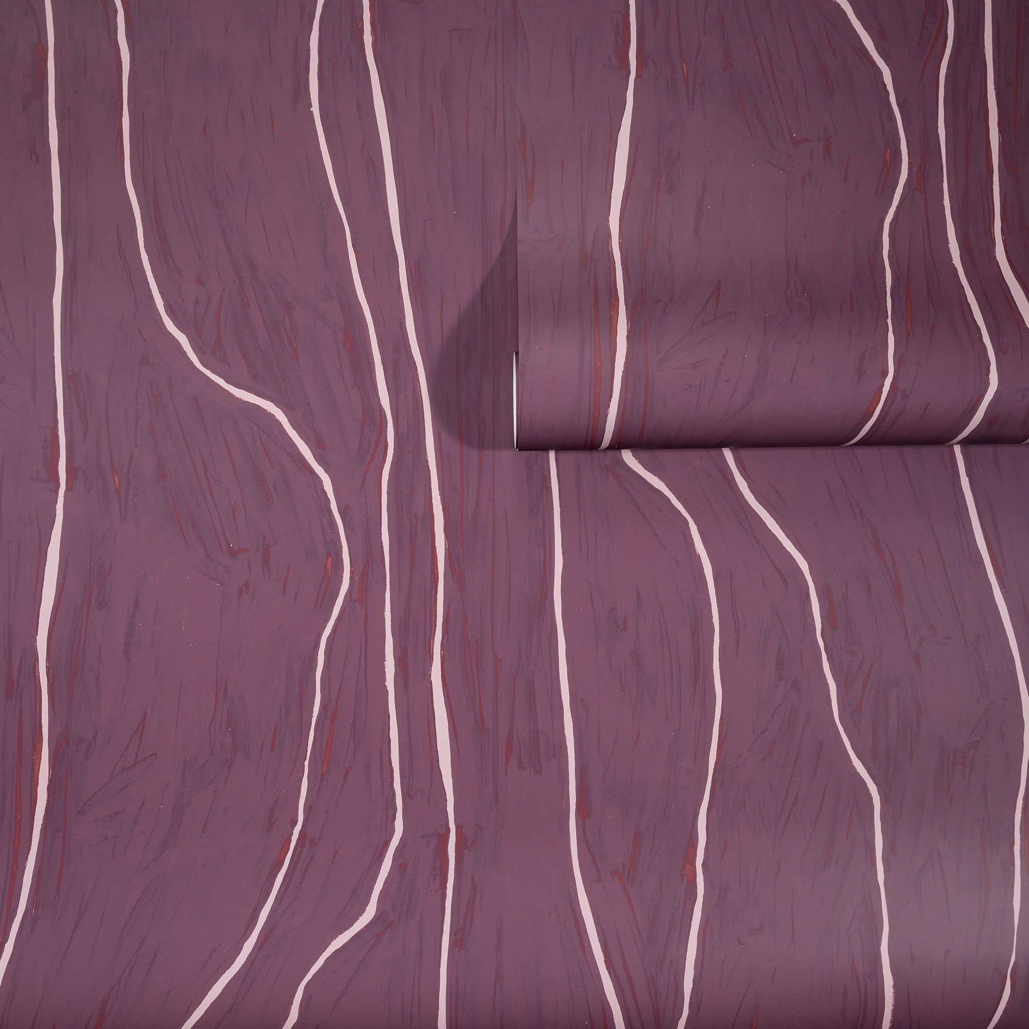 Deep plum wallpaper with soft pink wavy vertical lines, partially unrolled to highlight its rich color and organic pattern.