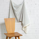 Light blue and cream striped linen fabric by the yard, draped to show pattern and scale