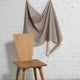 Tan and cream striped linen fabric by the yard, draped to show pattern and scale