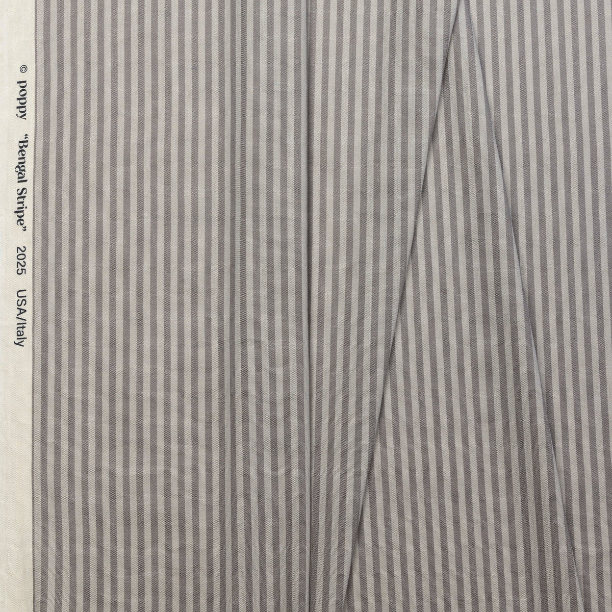 Tan and cream striped linen fabric by the yard, folded showing drape and weight