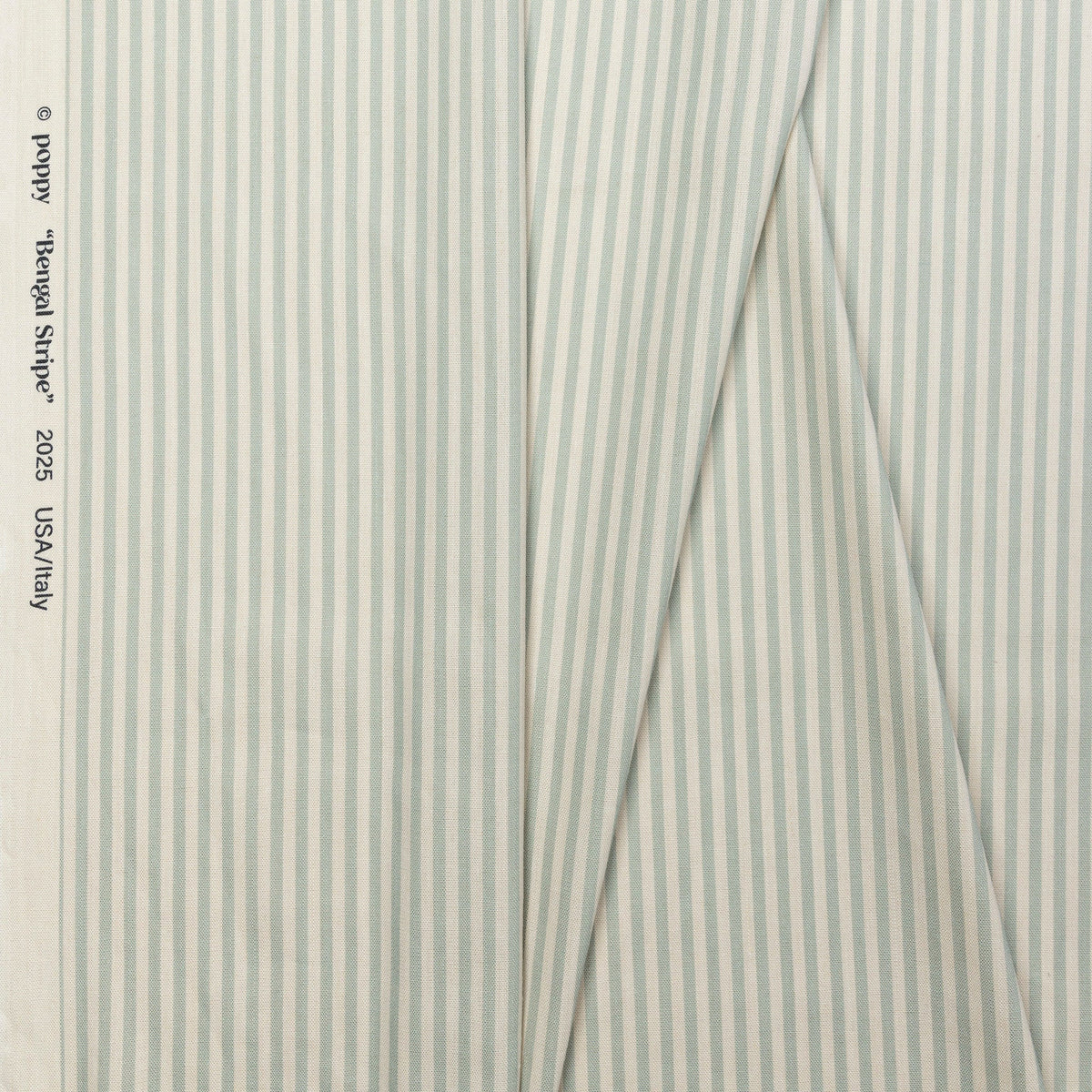 Sage green and cream striped linen fabric by the yard, folded showing drape and weight