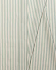 Sage green and cream striped linen fabric by the yard, folded showing drape and weight