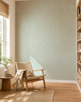 Pale aqua leafy floral commercial wallcovering installed in a sunlit reading nook