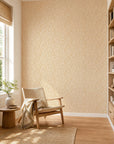 Golden yellow and cream leafy floral wallpaper installed in a sunlit reading nook