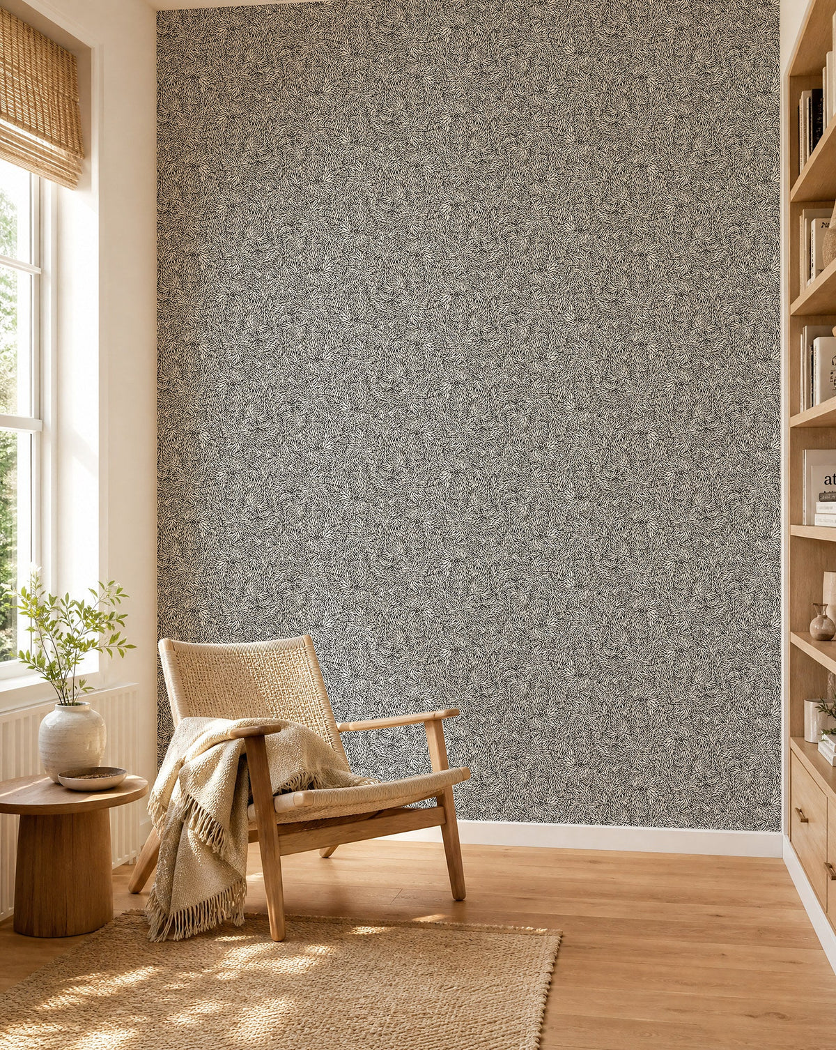 Black and cream leafy floral commercial wallcovering installed in a sunlit reading nook