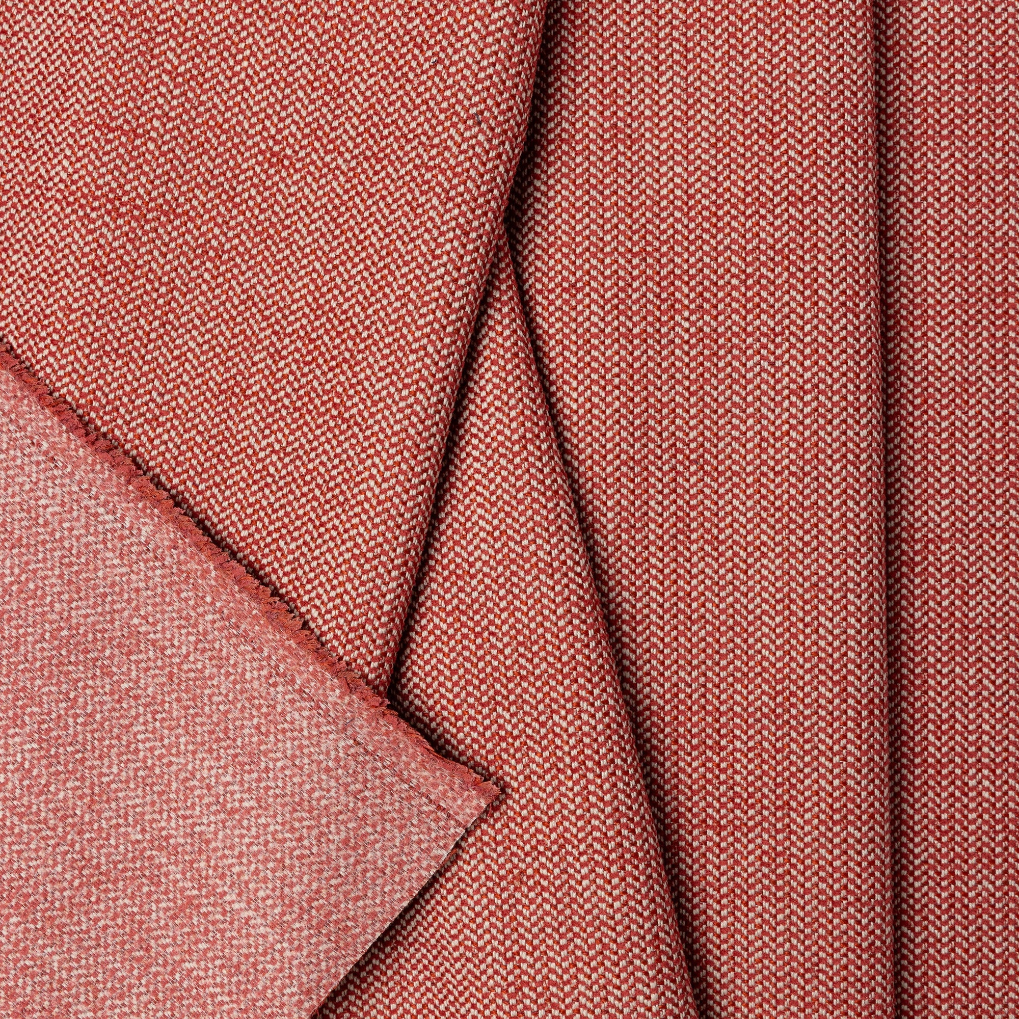 Pink herringbone outdoor fabric by the yard, folded showing drape and weight