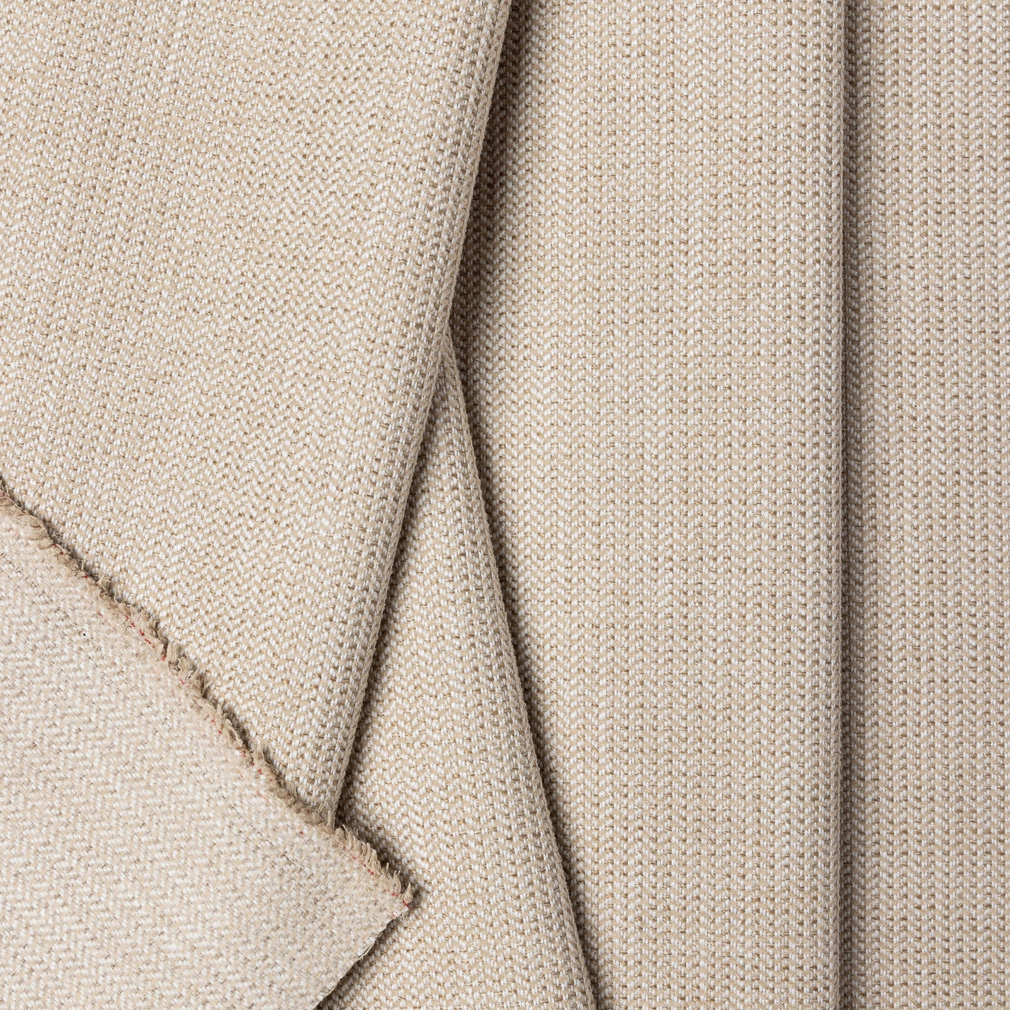 Beige herringbone outdoor fabric by the yard, folded showing drape and weight