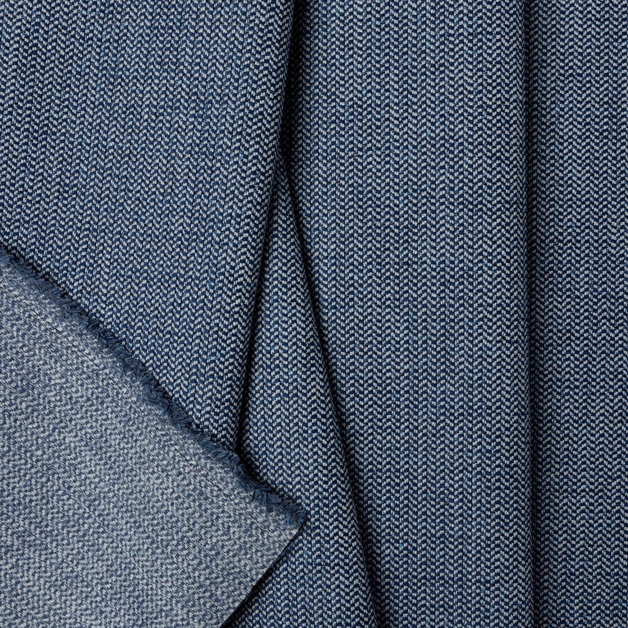 Blue herringbone outdoor fabric by the yard, folded showing drape and weight