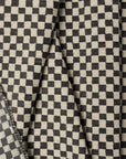 Black and ivory checkerboard jacquard upholstery fabric by the yard, folded showing drape and weight