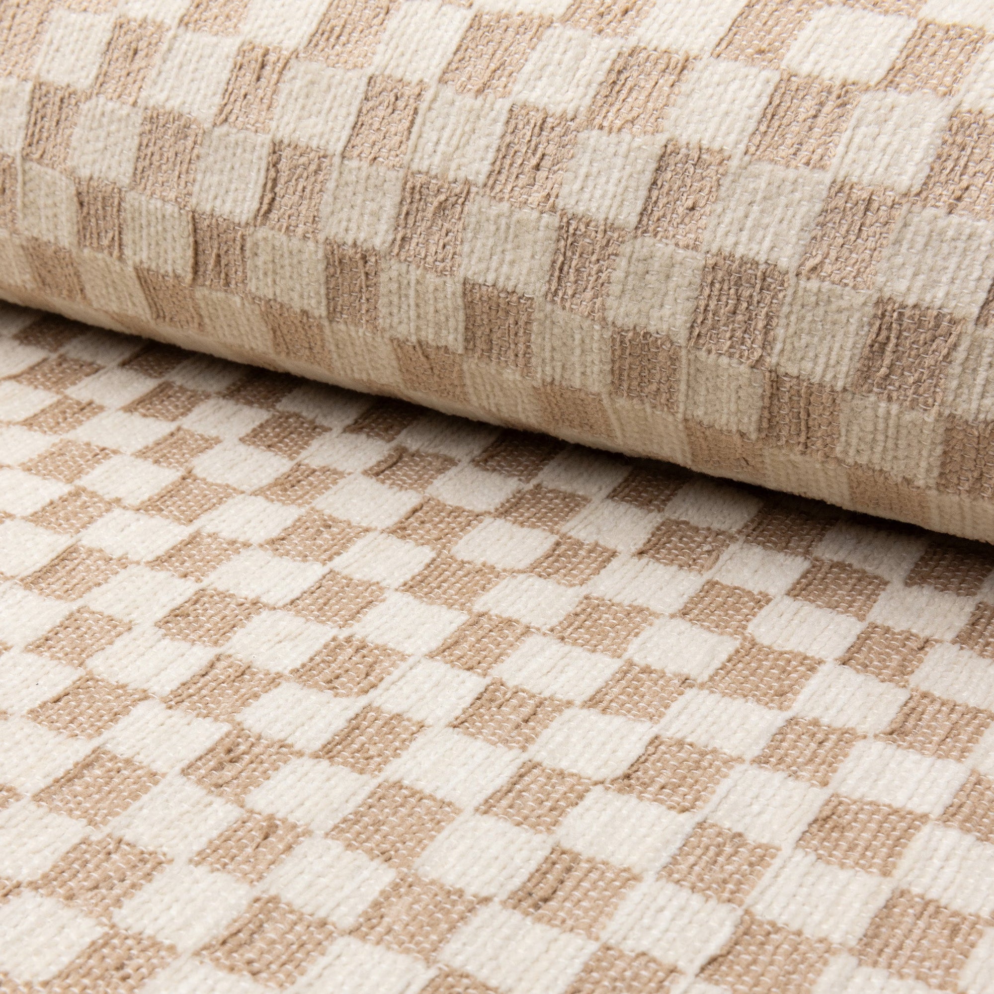 Cream and tan checkerboard jacquard upholstery fabric by the yard, rolled bolt view