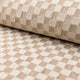 Cream and tan checkerboard jacquard upholstery fabric by the yard, rolled bolt view