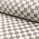 Light gray and cream checkerboard jacquard upholstery fabric by the yard, rolled bolt view