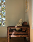 Olive green and cream checkerboard throw pillow styled on white boucle sofa