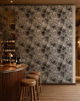 Black and white watercolor floral commercial wallcovering installed behind a wine bar