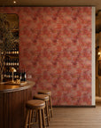 Coral and pink watercolor floral wallpaper installed behind a wine bar