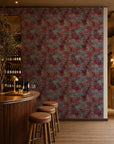 Red floral on dusty blue wallpaper installed behind a wine bar