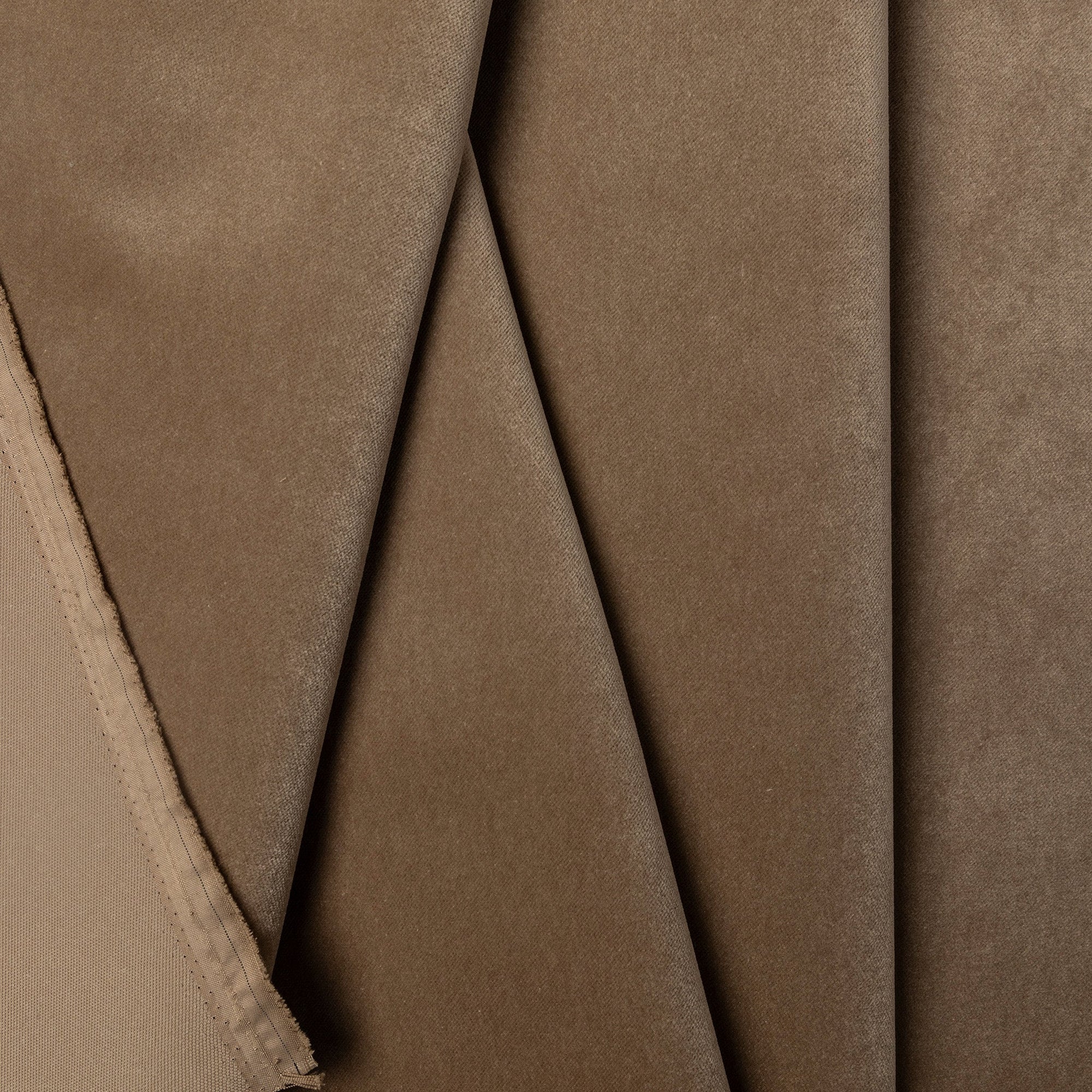 Tan velveteen upholstery fabric by the yard, folded showing drape and weight