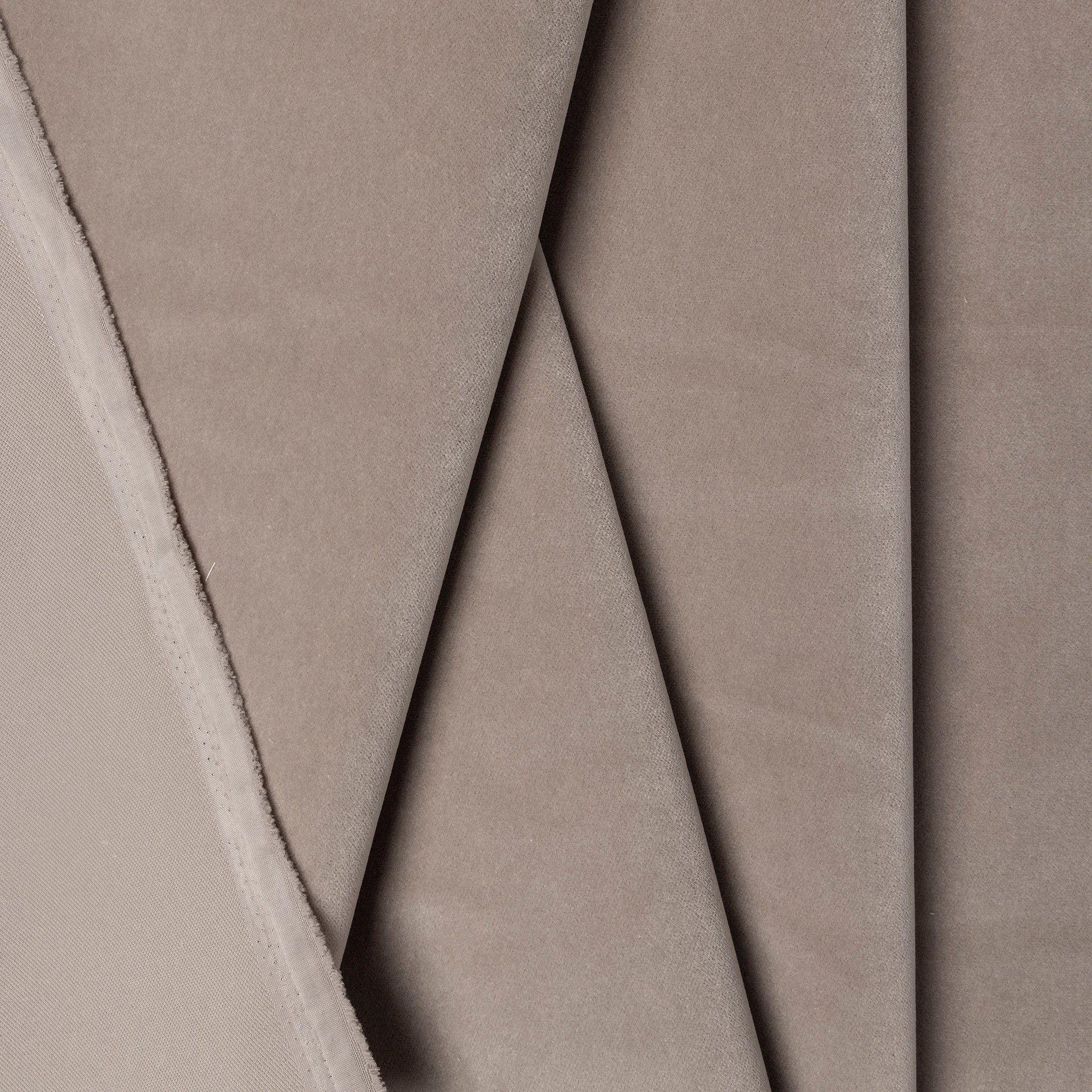 Gray velveteen upholstery fabric by the yard, folded showing drape and weight