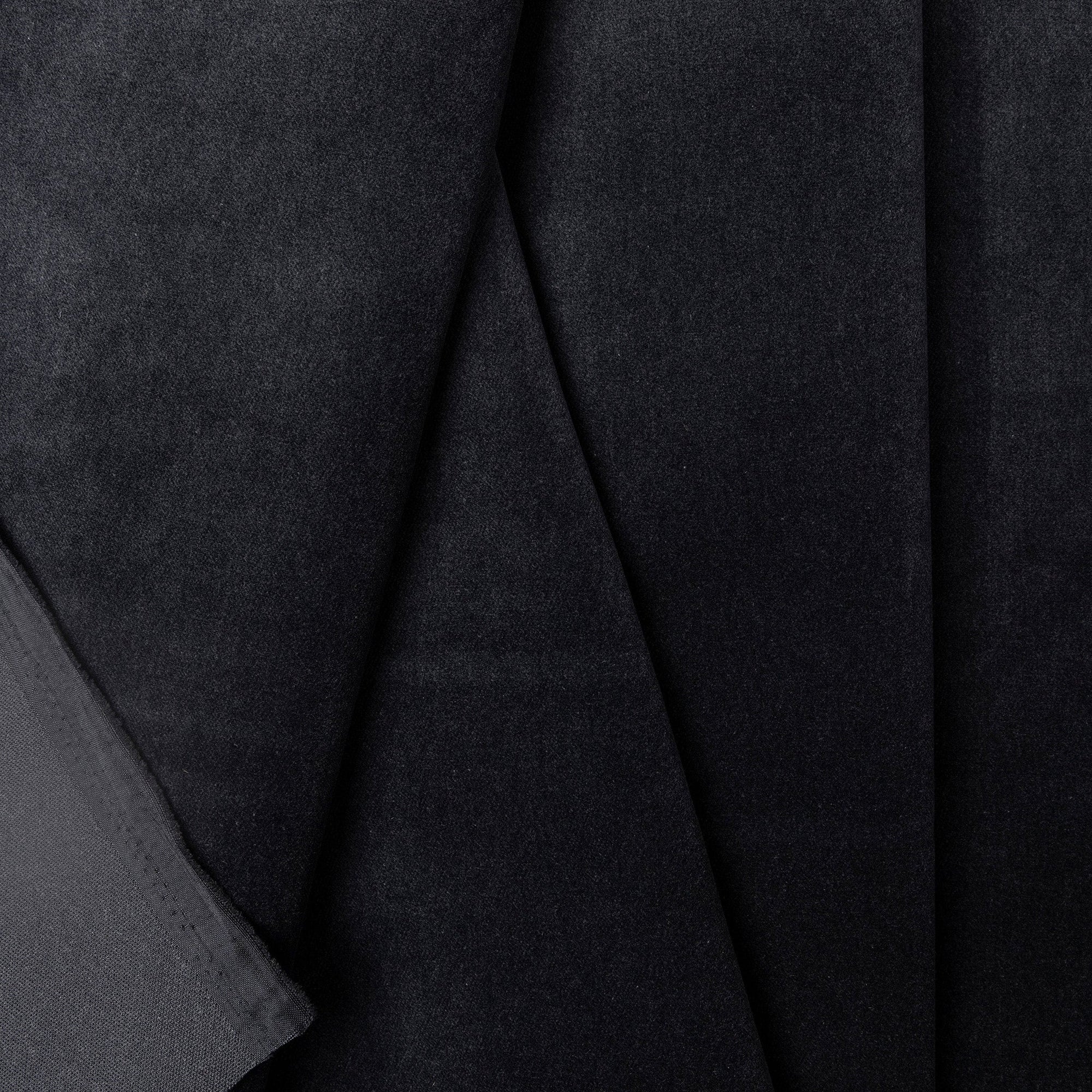 Black velveteen upholstery fabric by the yard, folded showing drape and weight