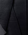 Black velveteen upholstery fabric by the yard, folded showing drape and weight