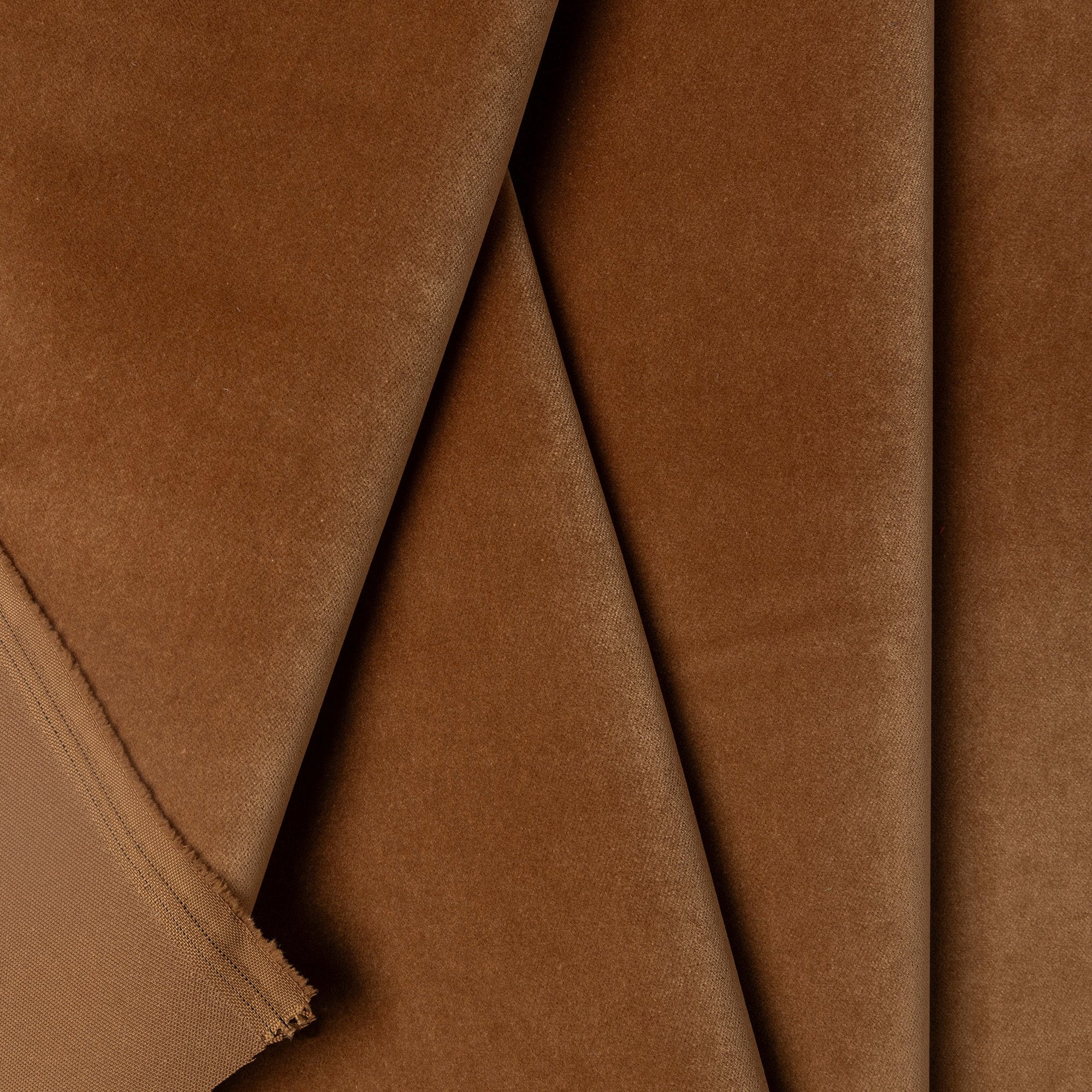 Brown velveteen upholstery fabric by the yard, folded showing drape and weight