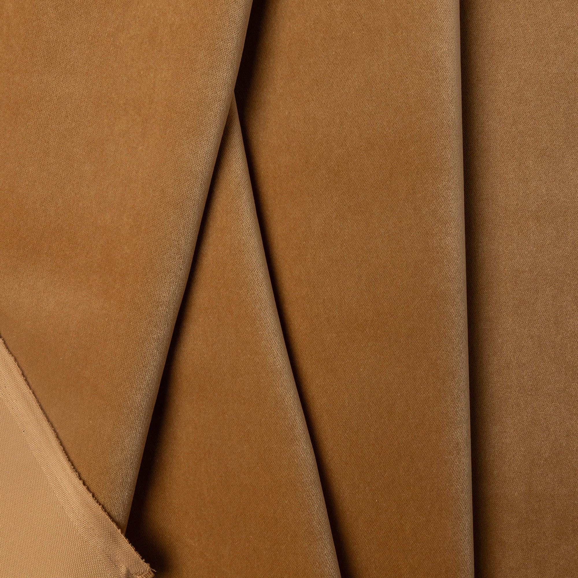 Brown velveteen upholstery fabric by the yard, folded showing drape and weight