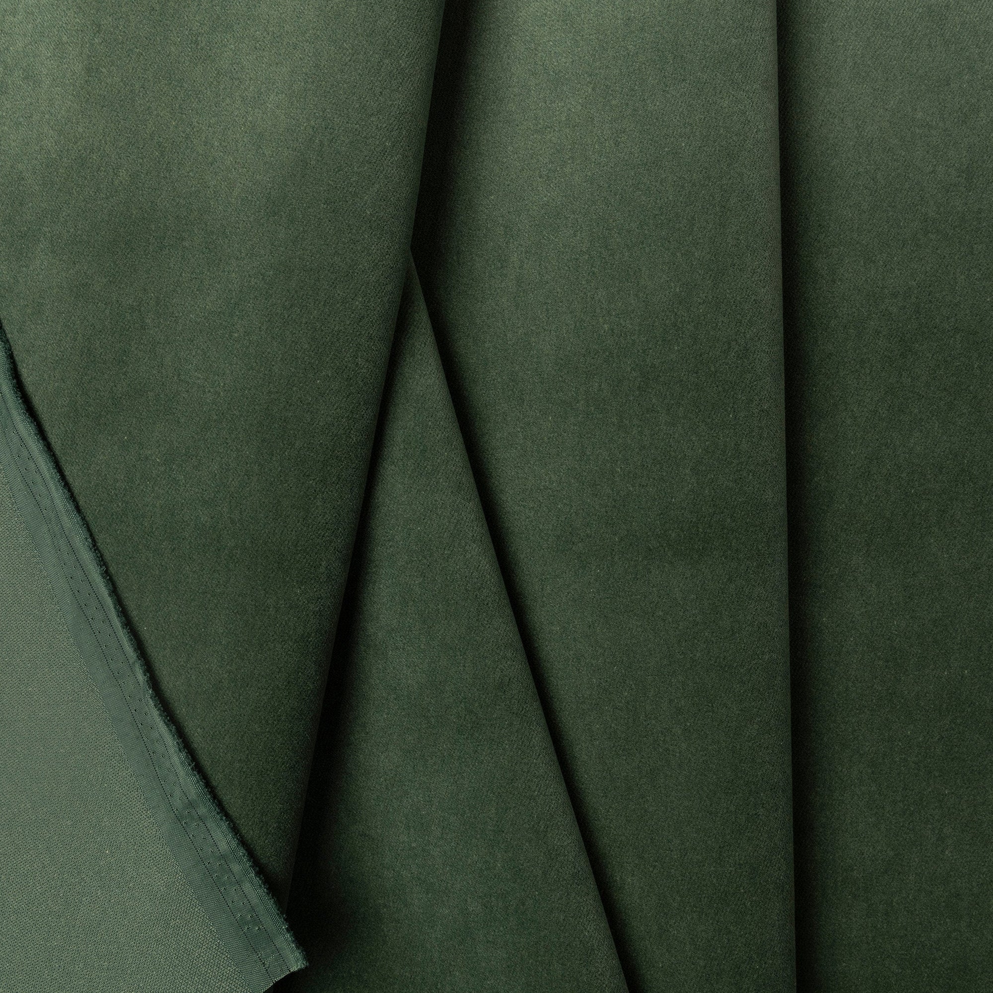 Forest green velveteen upholstery fabric by the yard, folded showing drape and weight