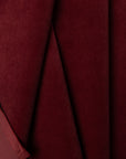 Burgundy velveteen upholstery fabric by the yard, folded showing drape and weight