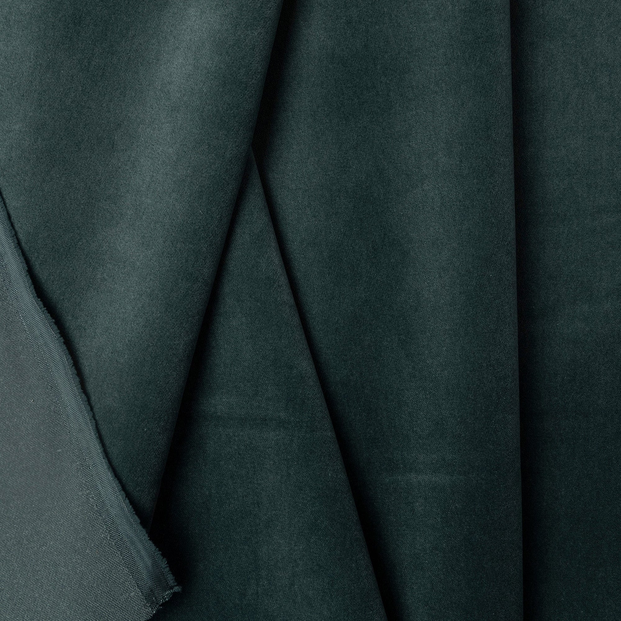 Blue-green velveteen upholstery fabric by the yard, folded showing drape and weight