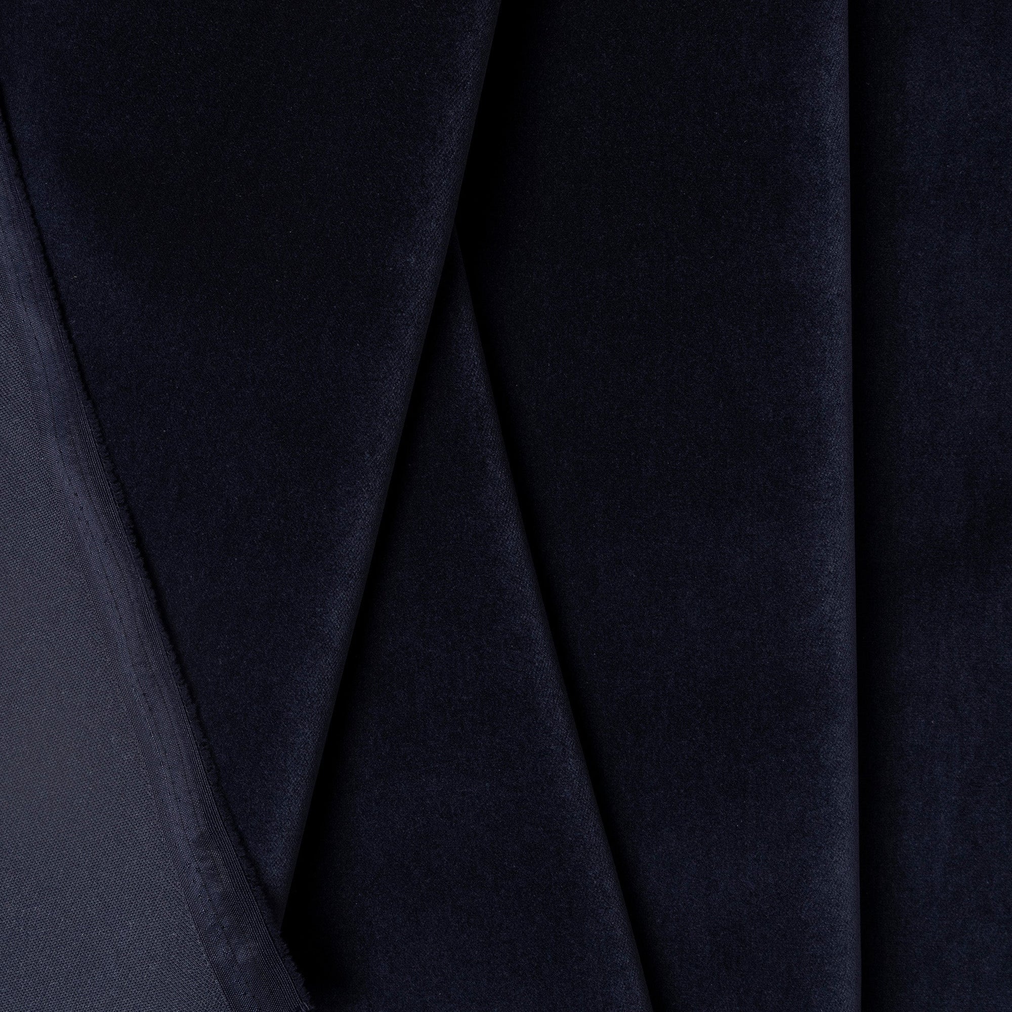 Navy velveteen upholstery fabric by the yard, folded showing drape and weight