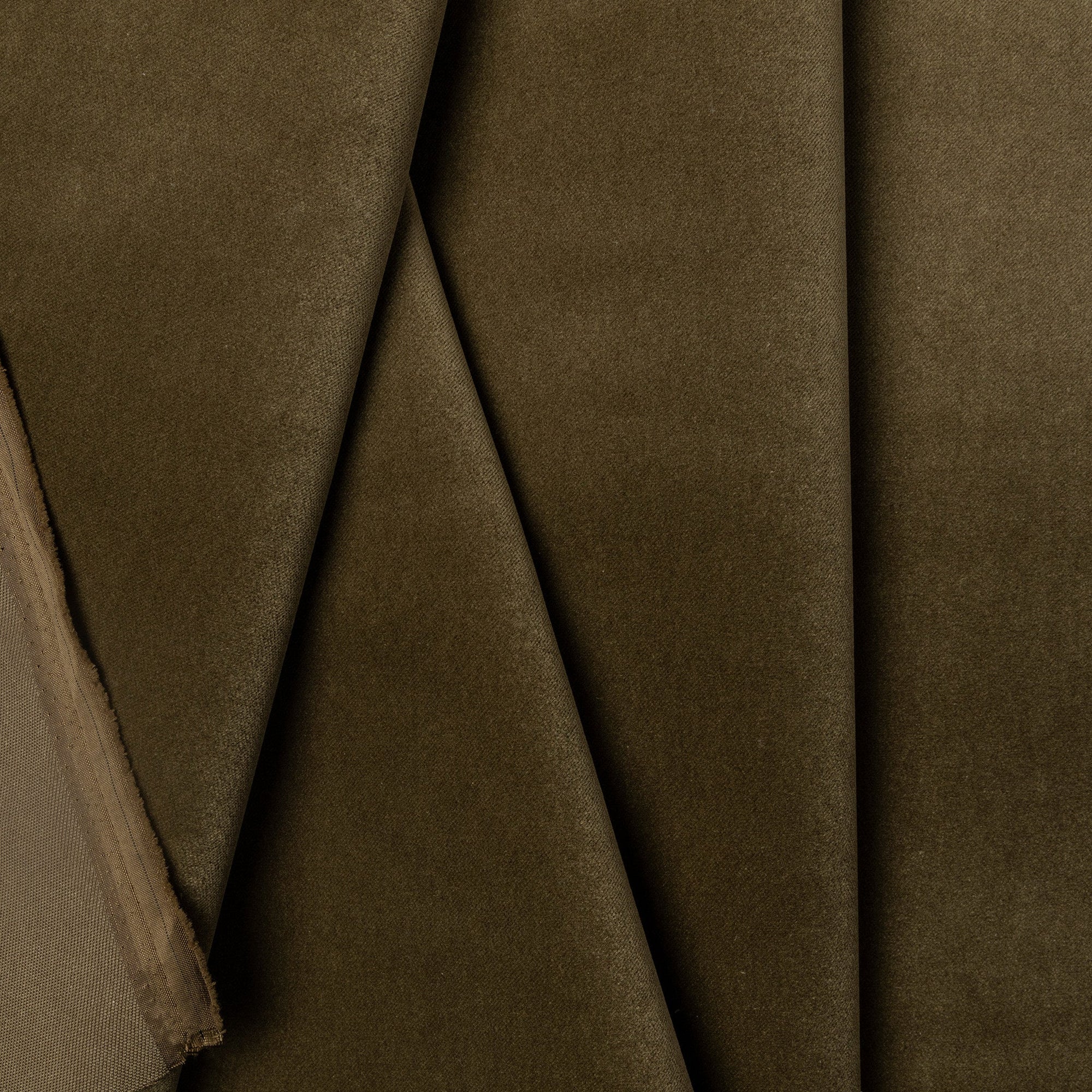 Green velveteen upholstery fabric by the yard, folded showing drape and weight