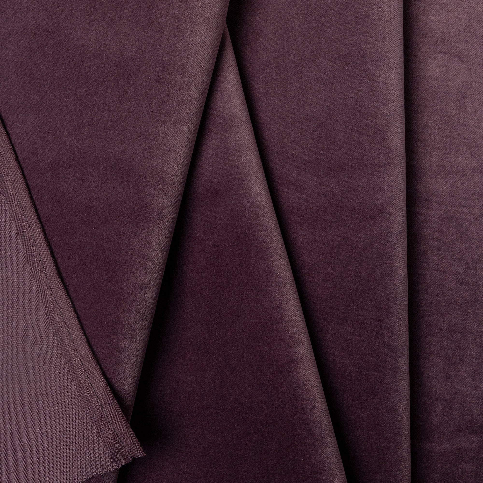 Purple velveteen upholstery fabric by the yard, folded showing drape and weight