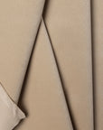 Beige velveteen upholstery fabric by the yard, folded showing drape and weight