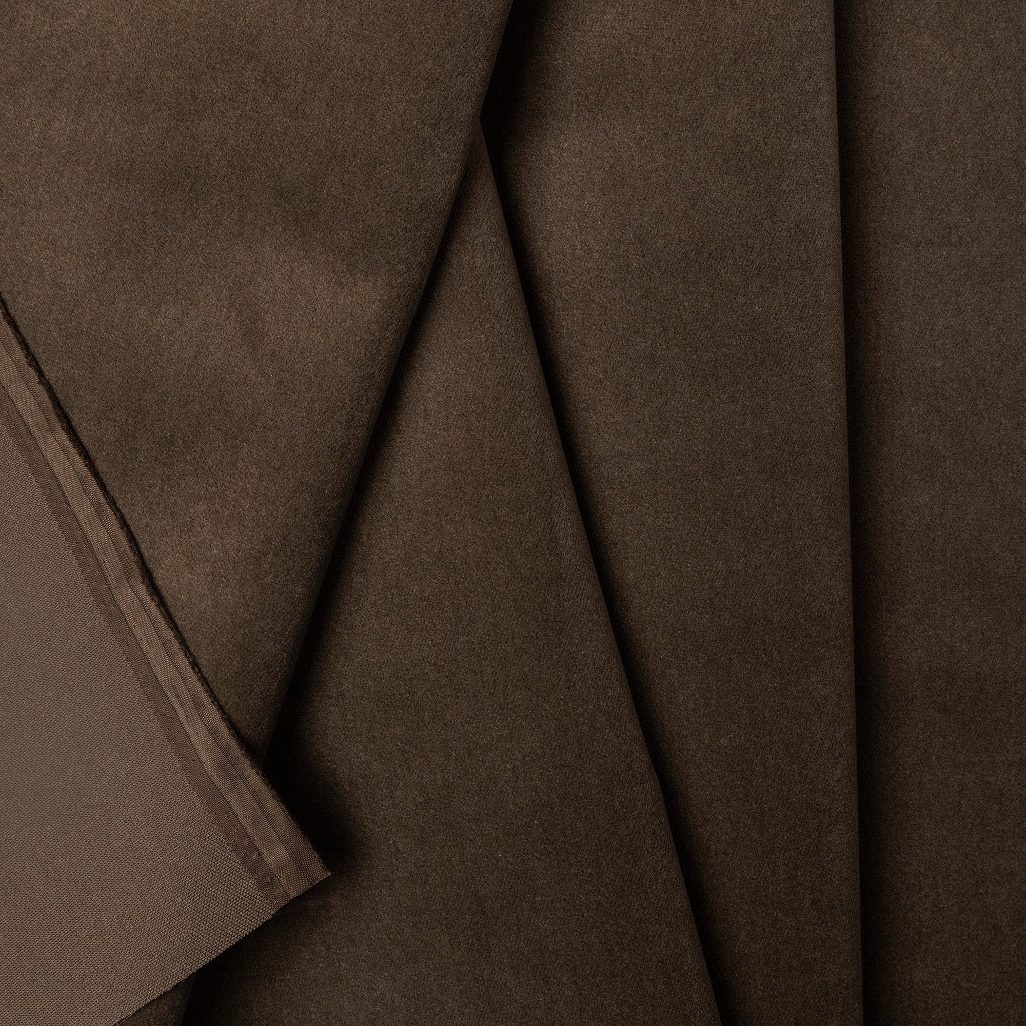 Brown velveteen upholstery fabric by the yard, folded showing drape and weight