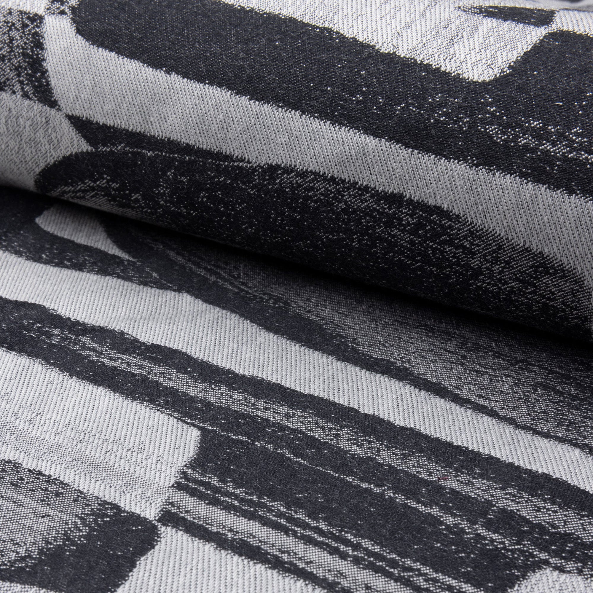 Black and gray abstract jacquard upholstery fabric by the yard, rolled bolt view