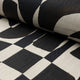 Black and cream abstract printed linen fabric by the yard, rolled bolt view