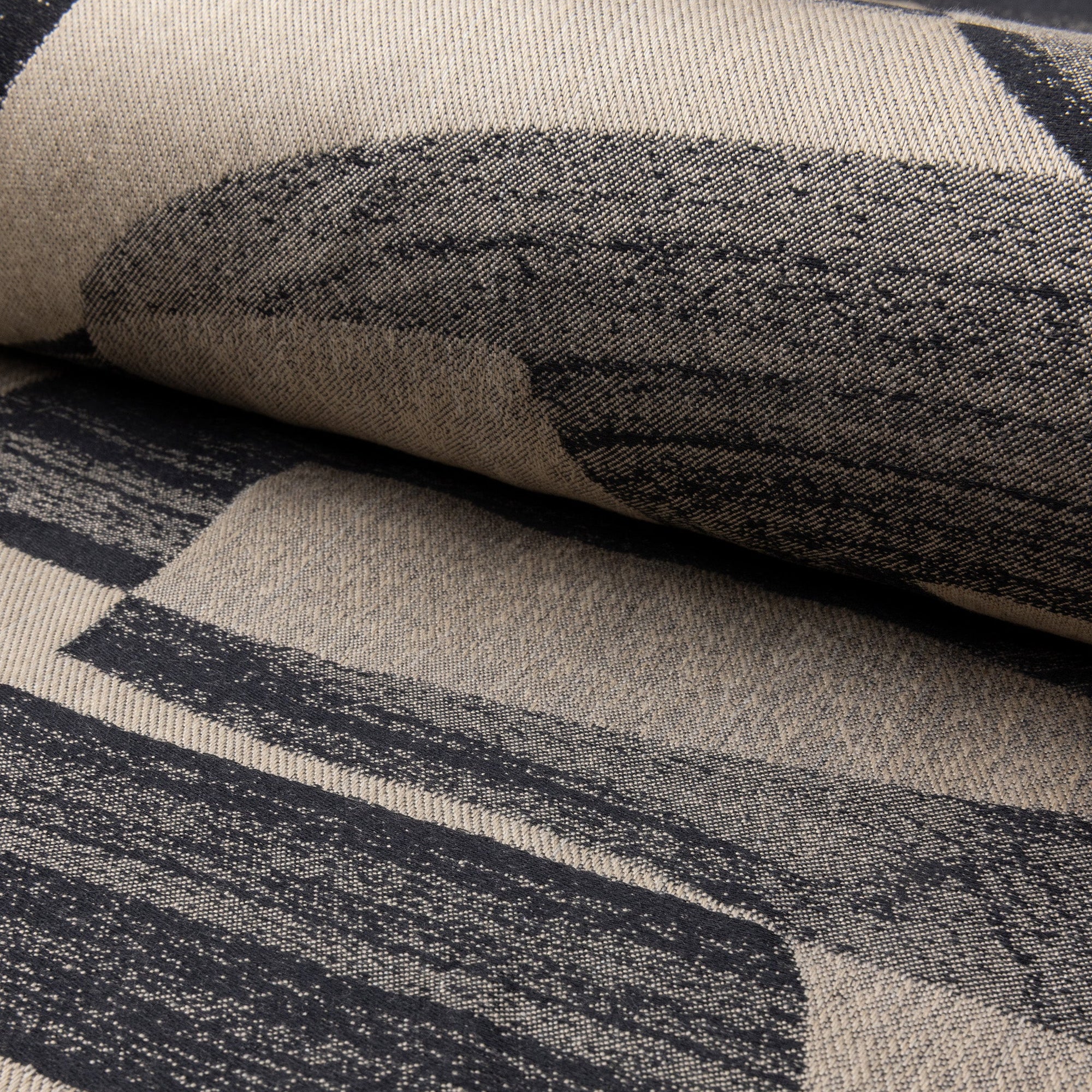 Champagne and black abstract jacquard upholstery fabric by the yard, rolled bolt view