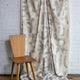 Gray and cream abstract printed linen fabric by the yard, draped to show pattern and scale