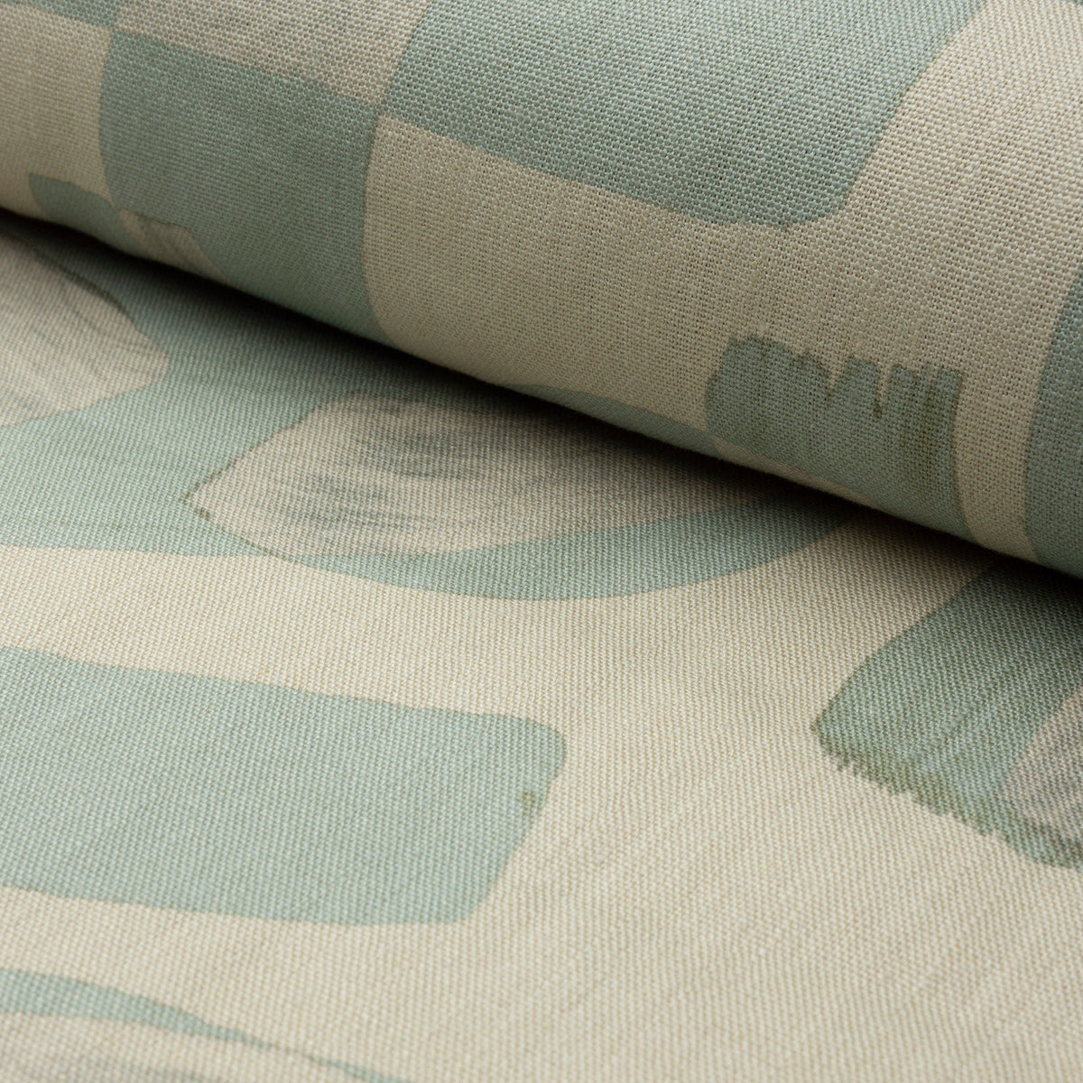 Sage green and cream abstract printed linen fabric by the yard, rolled bolt view