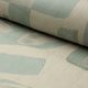 Sage green and cream abstract printed linen fabric by the yard, rolled bolt view