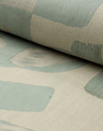 Sage green and cream abstract printed linen fabric by the yard, rolled bolt view