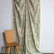 Sage green and cream abstract printed linen fabric by the yard, draped to show pattern and scale