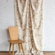 Beige and cream abstract printed linen fabric by the yard, draped to show pattern and scale