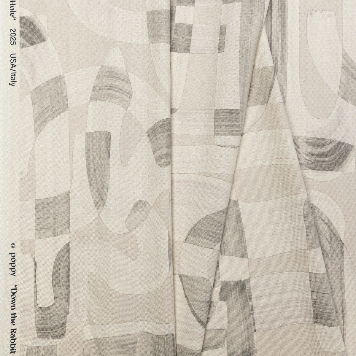 Beige and cream abstract printed linen fabric by the yard, folded showing drape and weight