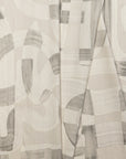 Beige and cream abstract printed linen fabric by the yard, folded showing drape and weight