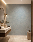 Pale blue feather print wallpaper installed in a powder room