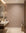 Soft taupe feather print commercial wallcovering installed in a powder room