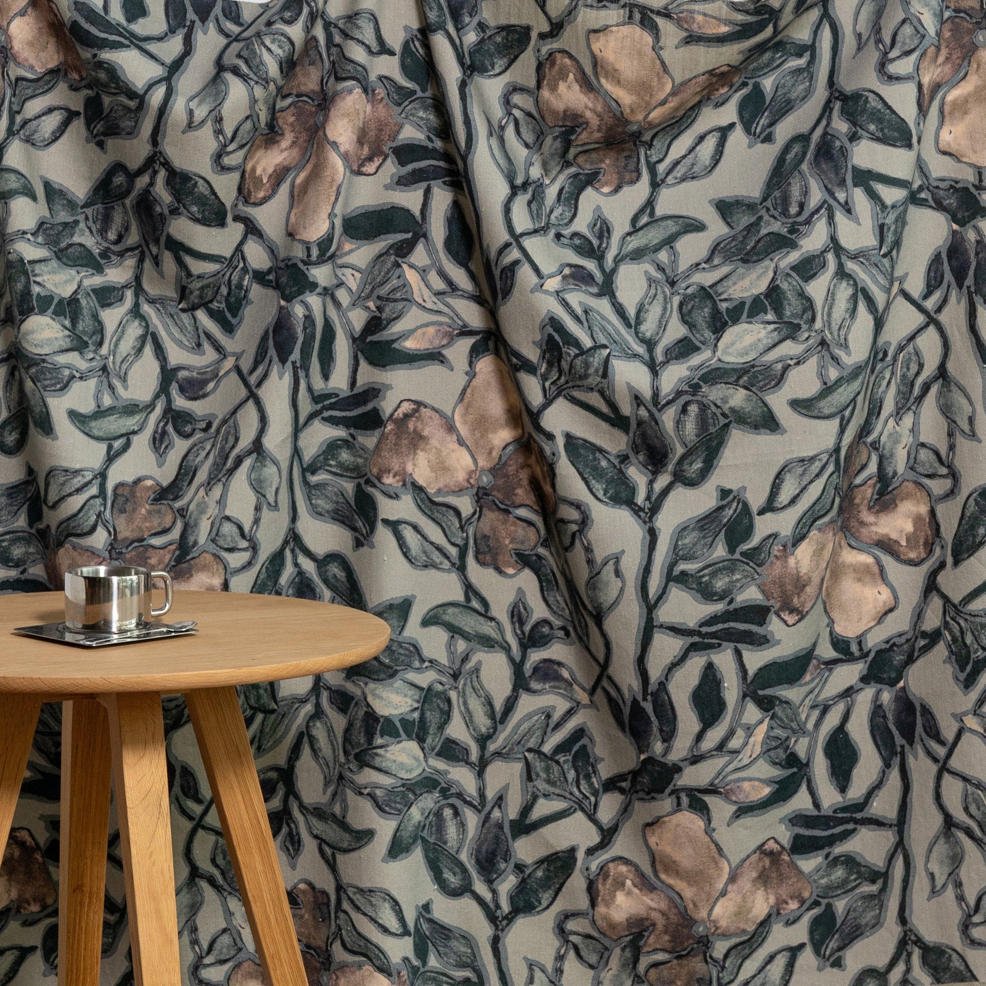Dusky blue and coral floral printed linen fabric by the yard, draped to show pattern and scale