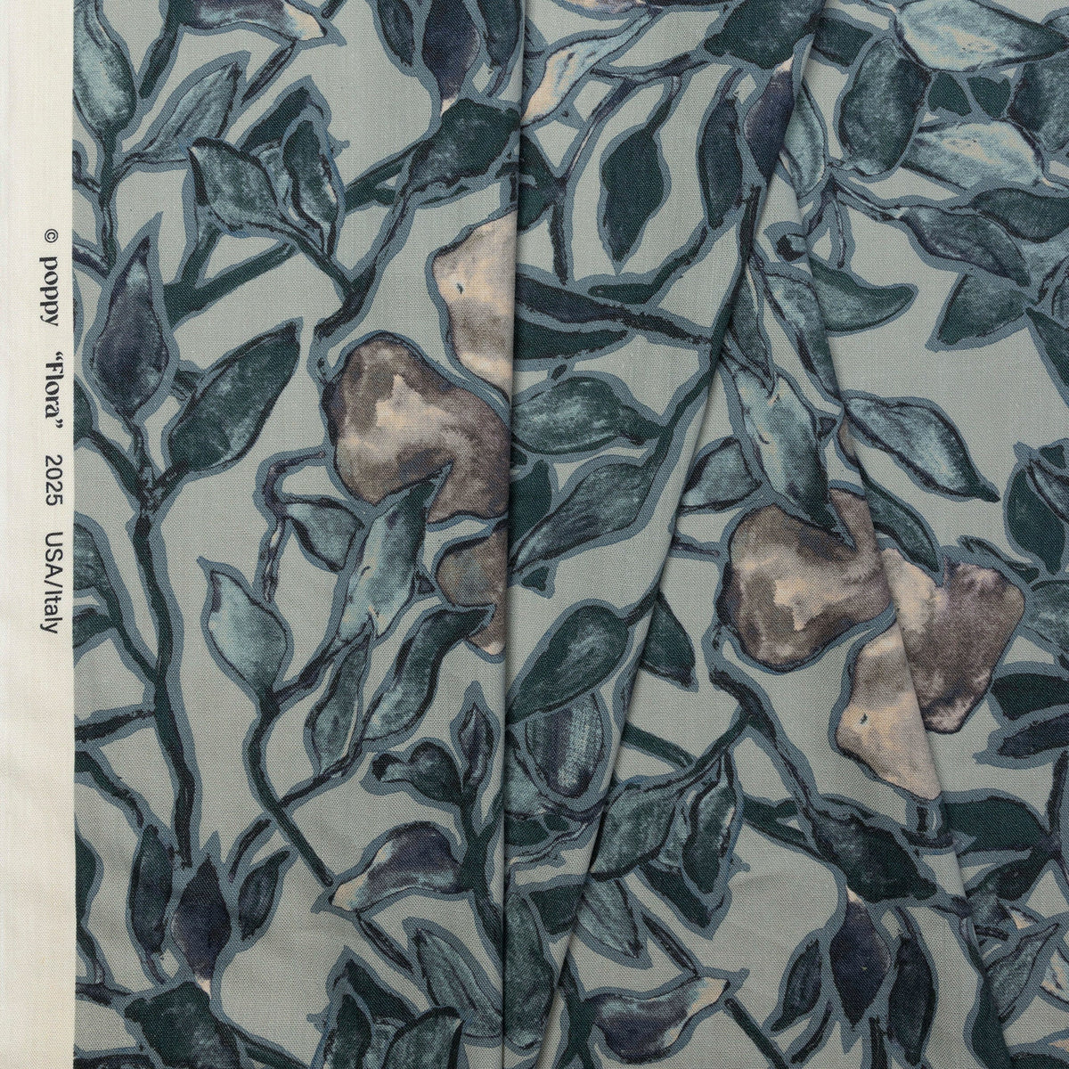 Dusky blue and coral floral printed linen fabric by the yard, folded showing drape and weight
