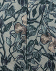 Dusky blue and coral floral printed linen fabric by the yard, folded showing drape and weight